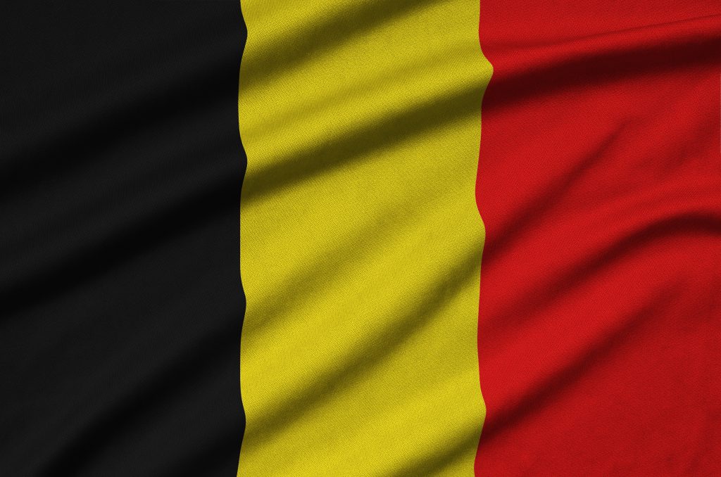 Belgium flag  is depicted on a sports cloth fabric with many folds. Sport team waving banner