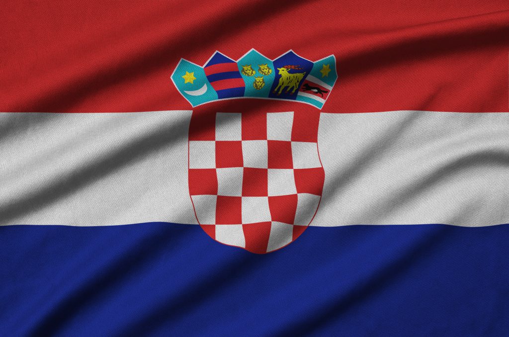 Croatia flag  is depicted on a sports cloth fabric with many folds. Sport team waving banner