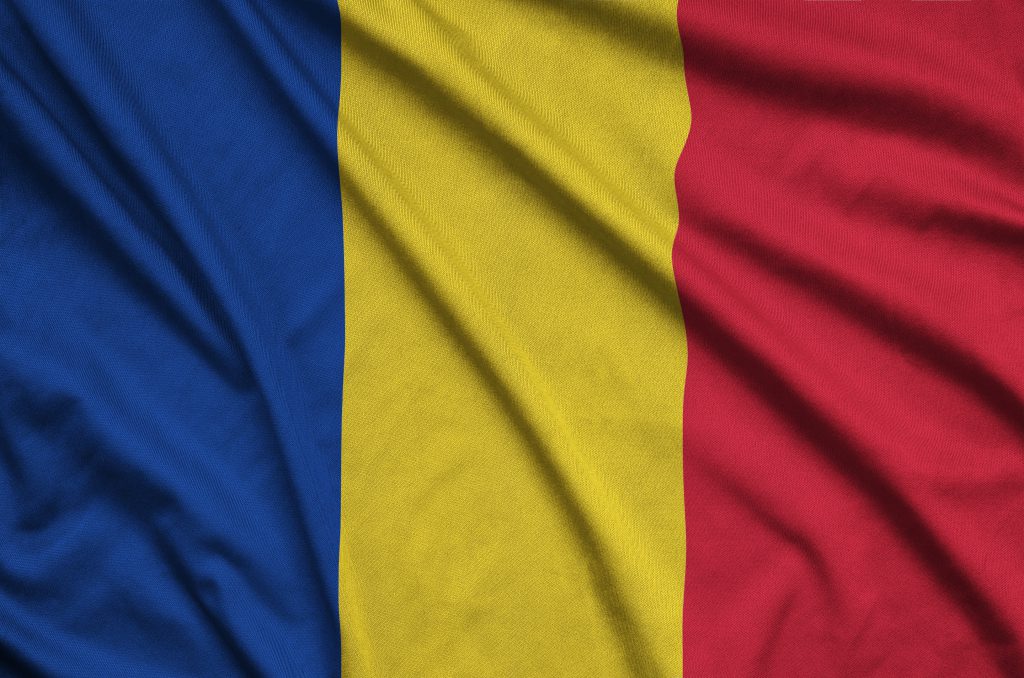 Romania flag  is depicted on a sports cloth fabric with many folds. Sport team waving banner